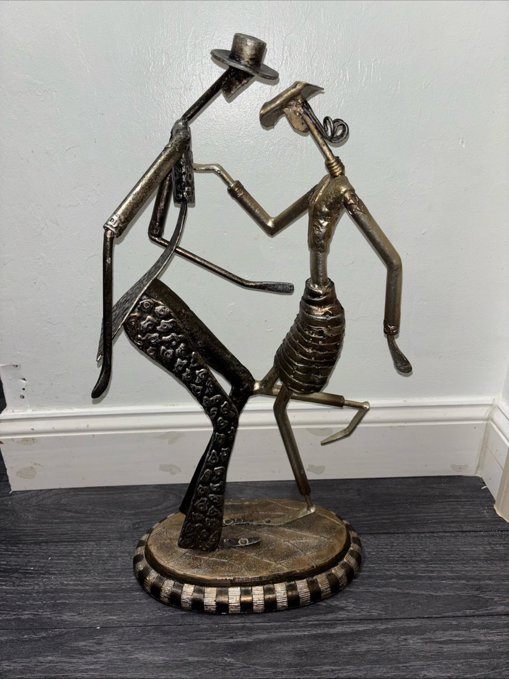 Folk art couple dancing tango. Welded iron